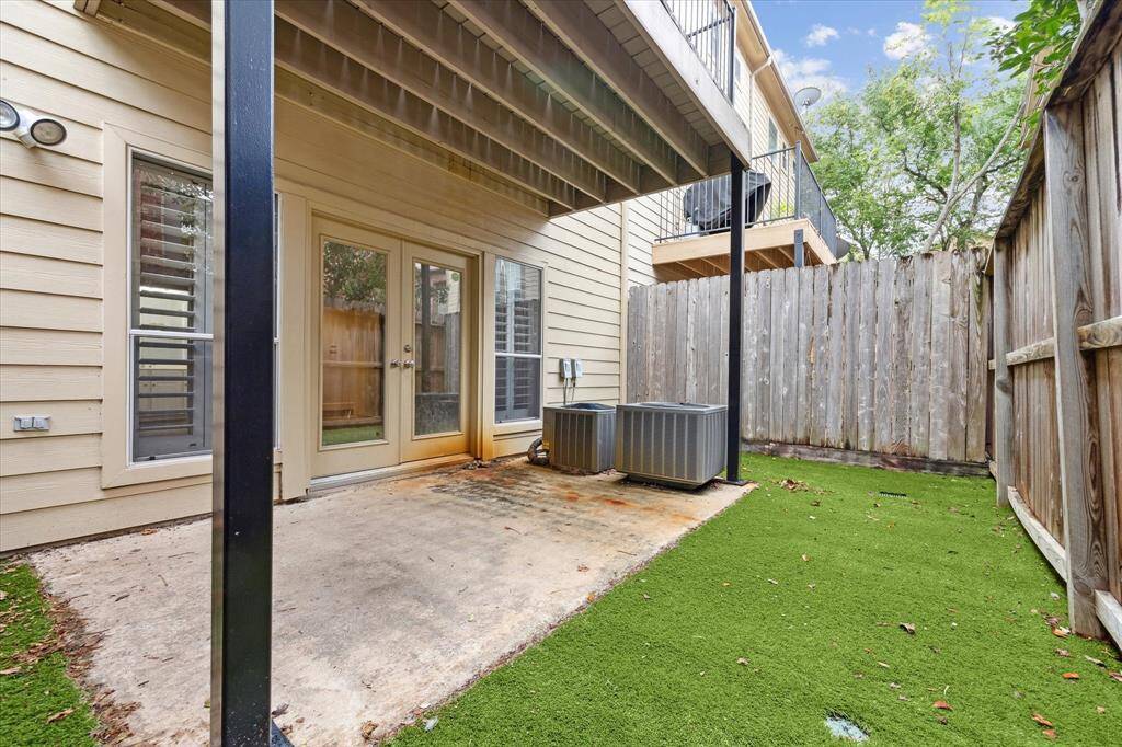 The patio off of the traditional bedroom on the 1st floor has lots of potential for many outdoor needs/wants. It is lined with turf and completely enclosed with a fence.