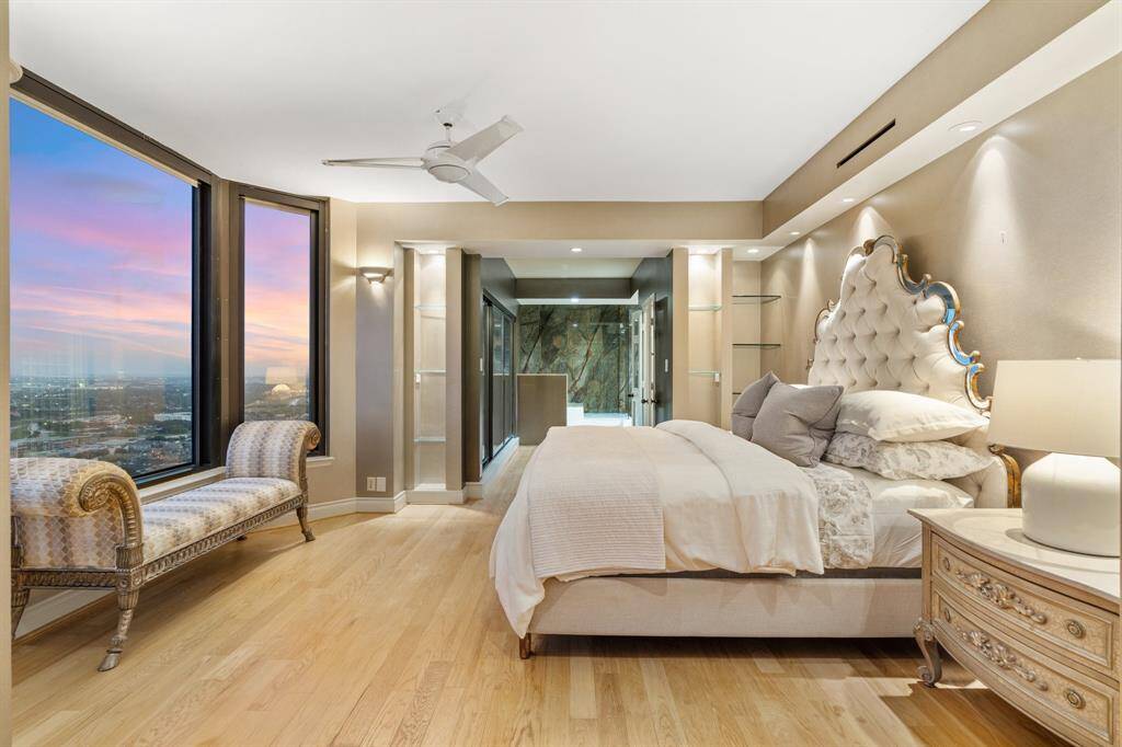 Primary suite open to the bathroom and access to a private balcony.