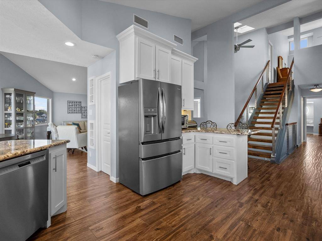Open Kitchen Flows into Cozy Living Space, and Open Cable Staircase Leading to Primary Suite