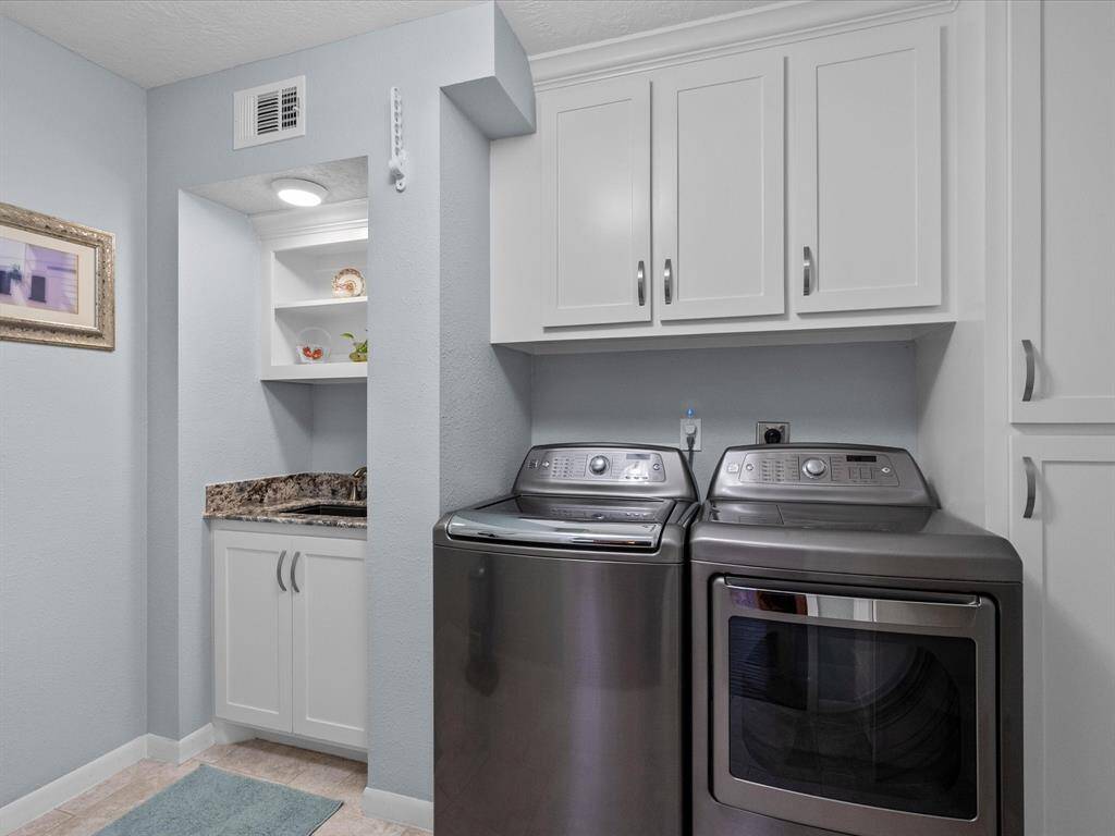 Full Sized Laundry, Work Space Sink and Plenty of Cabinet Storage