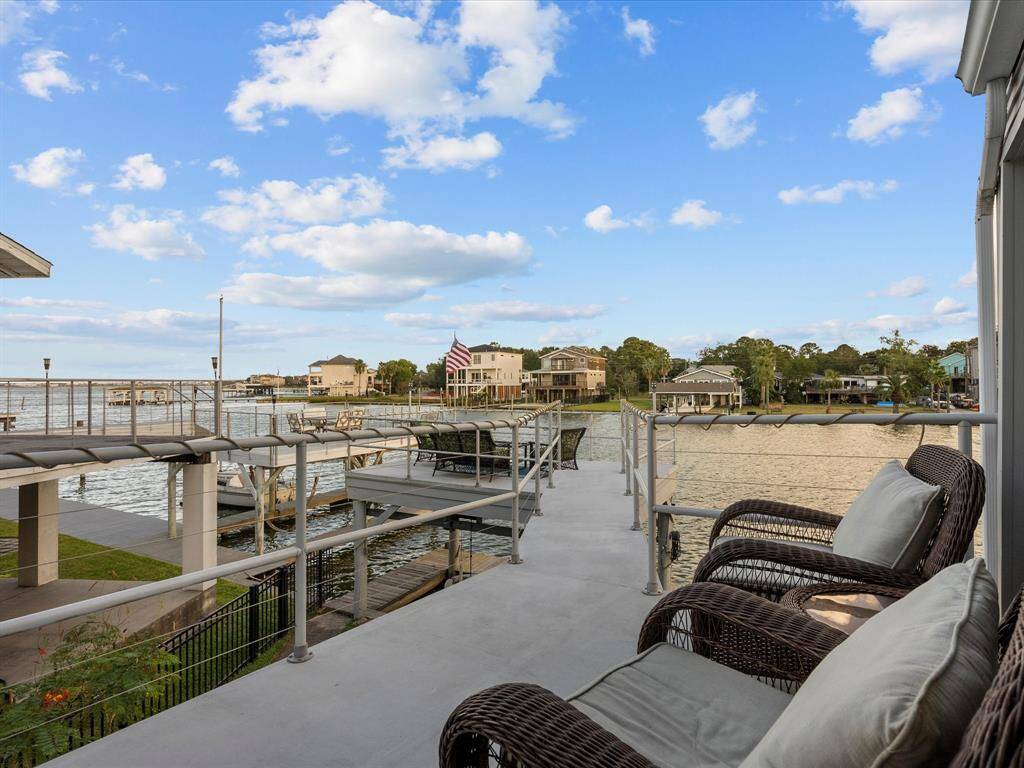 Spacious Waterfront Balcony with a Comfortable Seating Area, Offering Stunning Waterfront Views. The Perfect Spot for Relaxation and Entertainment.