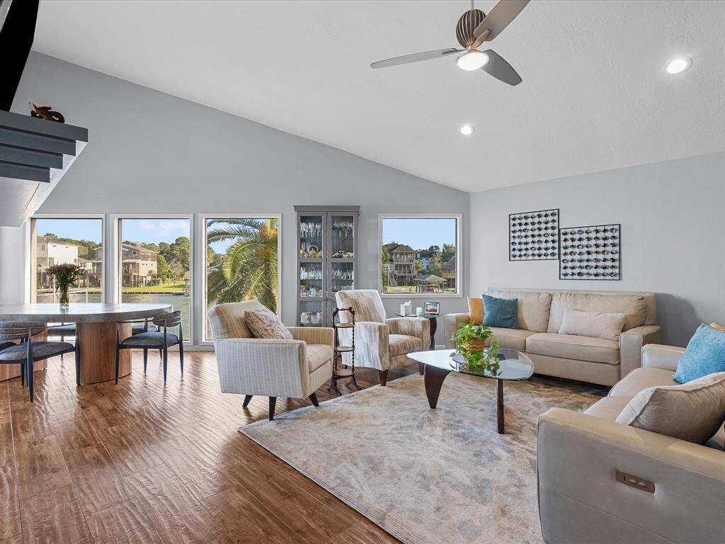 The Spacious and Bright Living Area  Features High Ceilings and Large Windows that Capture the Essence of Waterfront Living
