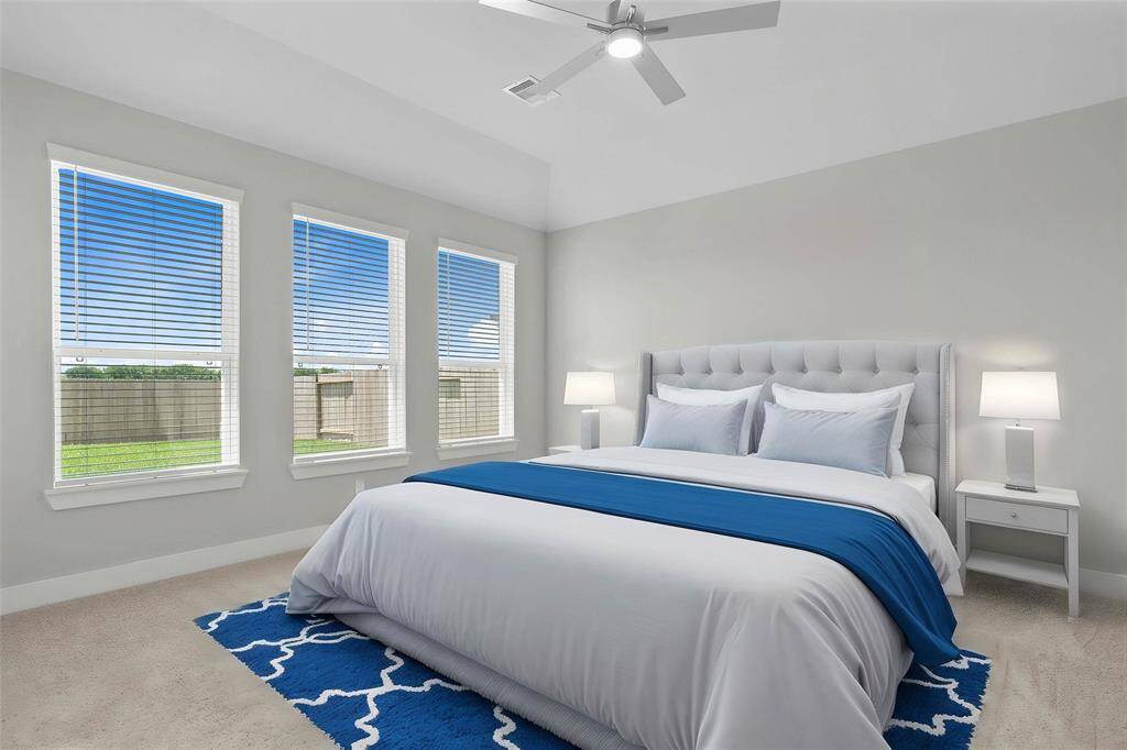 Come and unwind after a long day in this magnificent primary suite! This spacious room features plush carpet, warm paint, high ceilings, beautiful ceiling fan, and large windows with privacy blinds!