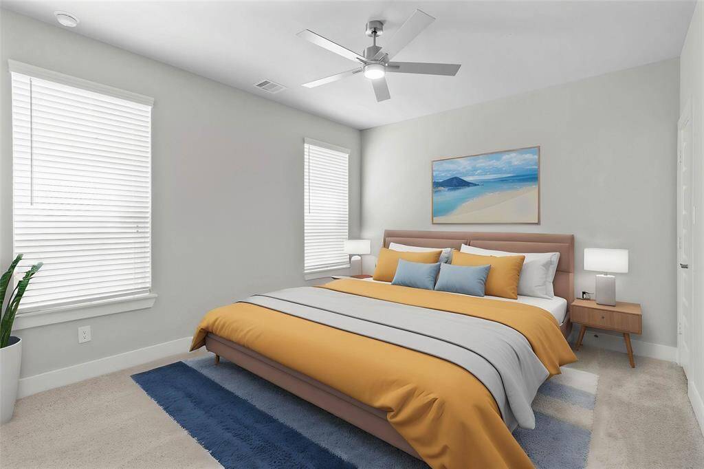 Nestled away quietly in the front of the home is a first floor secondary bedroom! Featuring high ceilings with ceiling fan, custom paint, plush carpet, and large windows with privacy blinds!