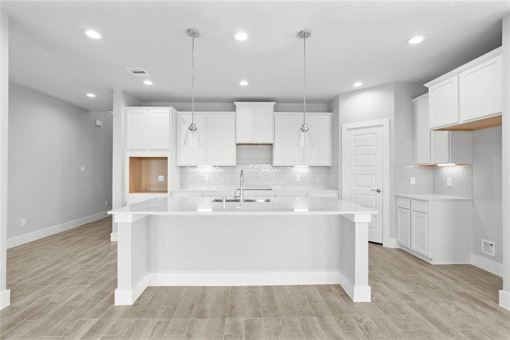 Additional view of the beautiful kitchen island and pendant lighting!