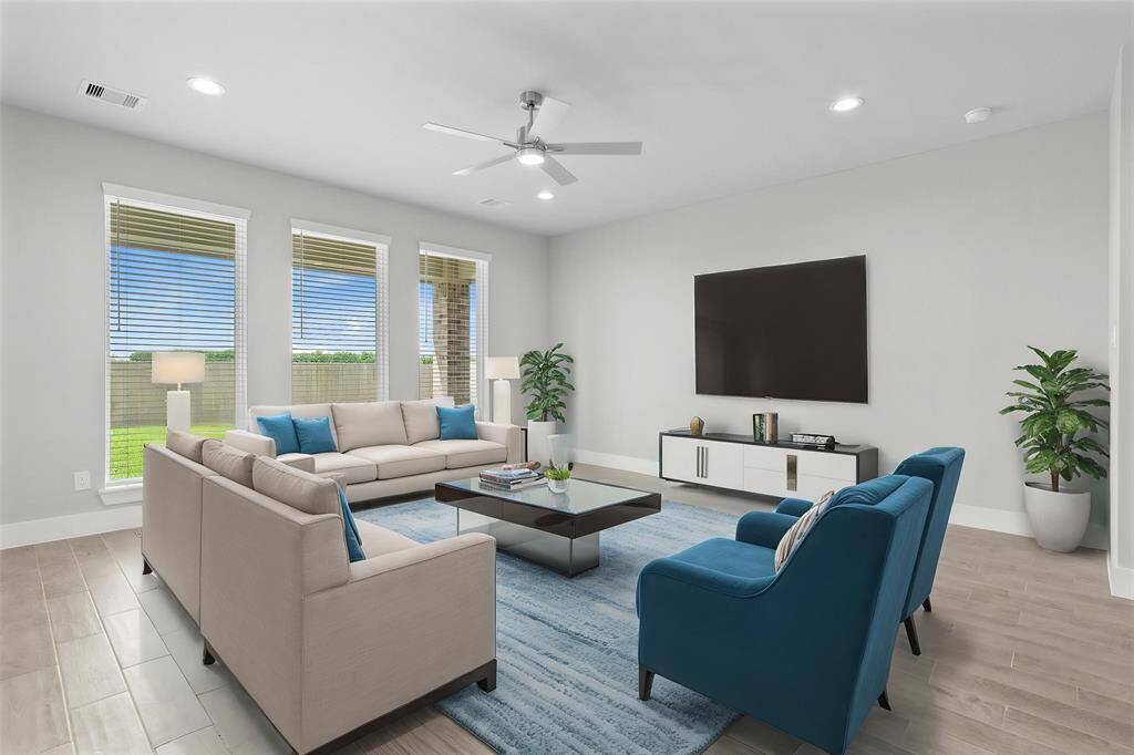 Gather the family and guests together in your lovely family room! Featuring high ceilings, recessed lighting, ceiling fan, custom paint, gorgeous wood look tile floors, and large windows that provide plenty of natural lighting throughout the day.