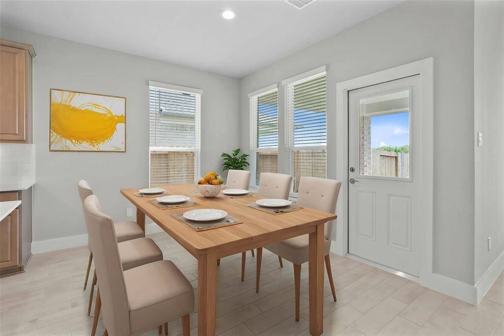 This primary bathroom is definitely move-in ready! Featuring stained cabinets with light countertops, spacious walk-in closet with shelving, high ceilings, custom paint, sleek and dark modern finishes.