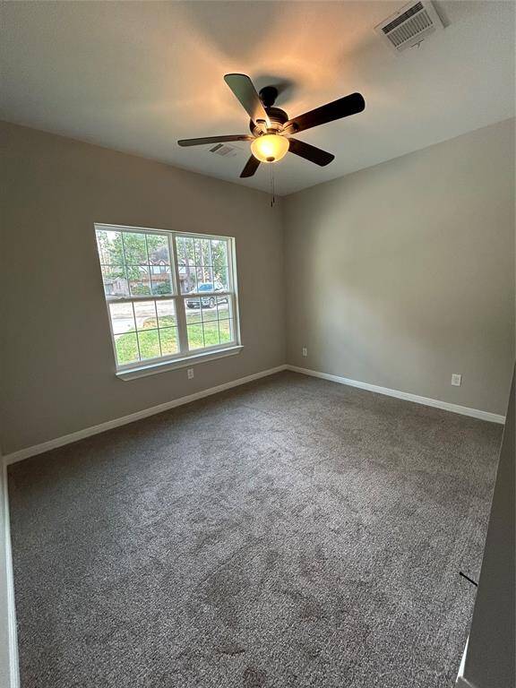 Step into this first bright bedroom with soft, plush carpeting and a large window facing the street, filling the room with natural light!