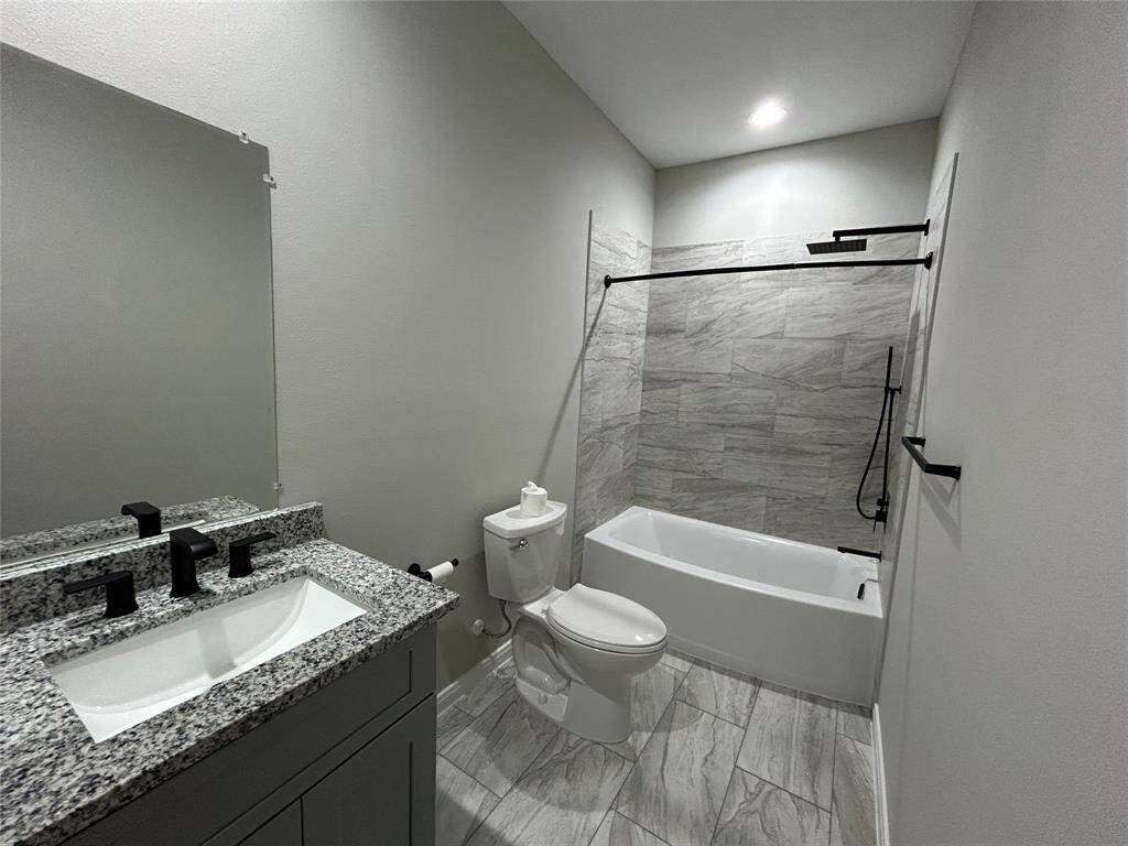This second full bathroom is right next door to the third bedroom, also featuring a spacious vanity and rain head in the shower!