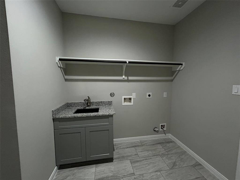 No more laundry day stress in this well-equipped space! With a built-in sink, stylish cabinets, and a storage shelf, this room is designed for full functionality! Just add your washer and dryer and you're all set!