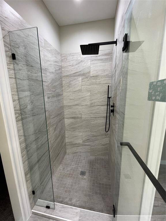 The walk-in shower surrounded by glass doors.