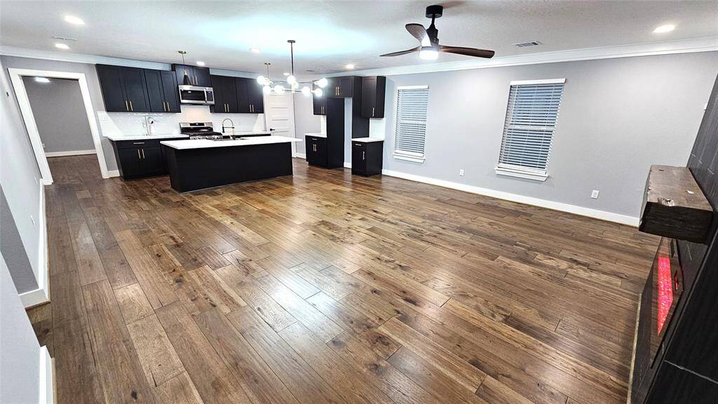 Beautiful Open Concept 30x20 Kitchen, Dining Room and Living Area.  Featuring Modern Fireplace, Solid Wood Matte Black Cabinets with Soft Close Doors/Drawers, Stainless Steel Samsung Smart Appliances, Brushed Gold Hardware and Lighting