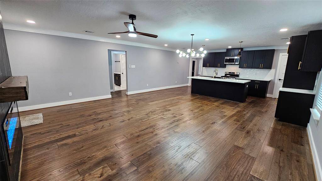 Beautiful Open Concept 30x20 Kitchen, Dining Room and Living Area.  Featuring Modern Fireplace, Solid Wood Matte Black Cabinets with Soft Close Doors/Drawers, Stainless Steel Samsung Smart Appliances, Brushed Gold Hardware and Lighting