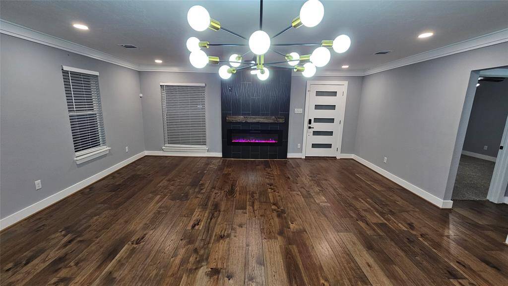 Beautiful Open Concept 30x20 Kitchen, Dining Room and Living Area.  Featuring Modern Fireplace, Solid Wood Matte Black Cabinets with Soft Close Doors/Drawers, Stainless Steel Samsung Smart Appliances, Brushed Gold Hardware and Lighting