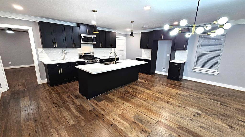 Beautiful Open Concept 30x20 Kitchen, Dining Room and Living Area. Featuring Modern Fireplace, Solid Wood Matte Black Cabinets with Soft Close Doors/Drawers, Stainless Steel Samsung Smart Appliances, Brushed Gold Hardware and Lighting
