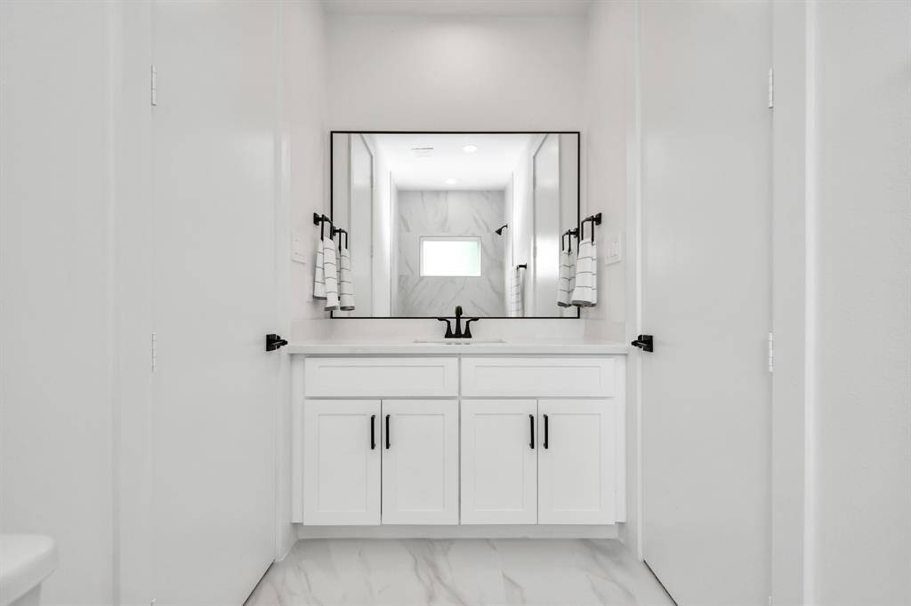 Picturesque large vanity and ample cabinet space complete the luxurious aesthetics of this gorgeous Jack and Jill