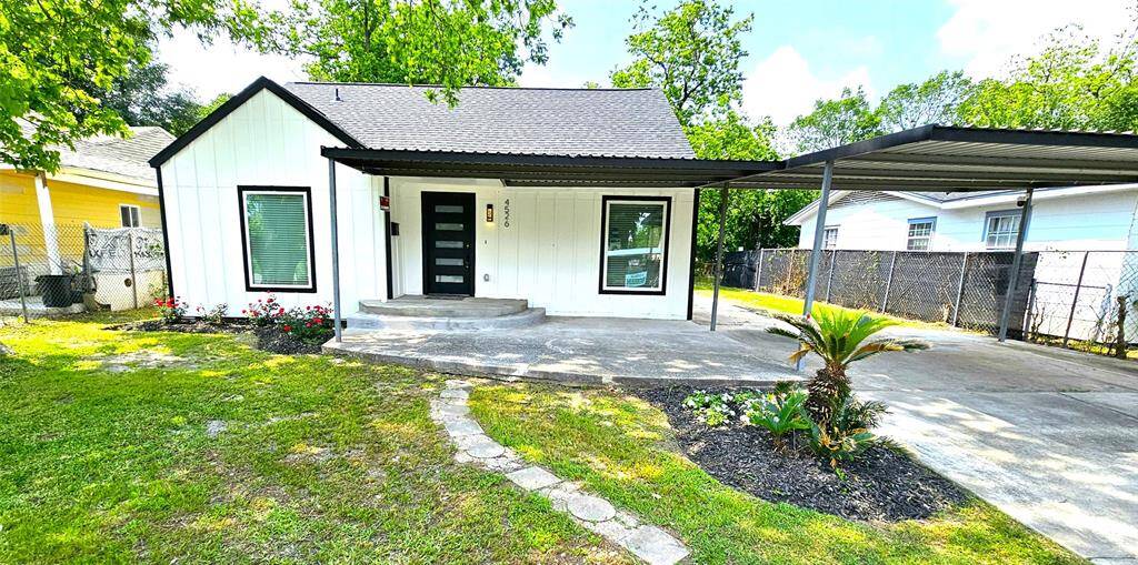 Beautiful Front Elevation with Covered Patio and Carport.  Featuring New Hardie Siding, New Windows, New Roof, Modern 5 Lite Front Door, LED Lighting, etc....