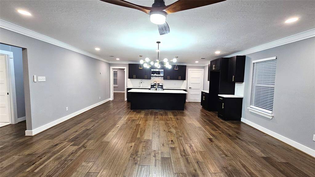Beautiful Open Concept 30x20 Kitchen, Dining Room and Living Area. Featuring Modern Fireplace, Solid Wood Matte Black Cabinets with Soft Close Doors/Drawers, Stainless Steel Samsung Smart Appliances, Brushed Gold Hardware and Lighting