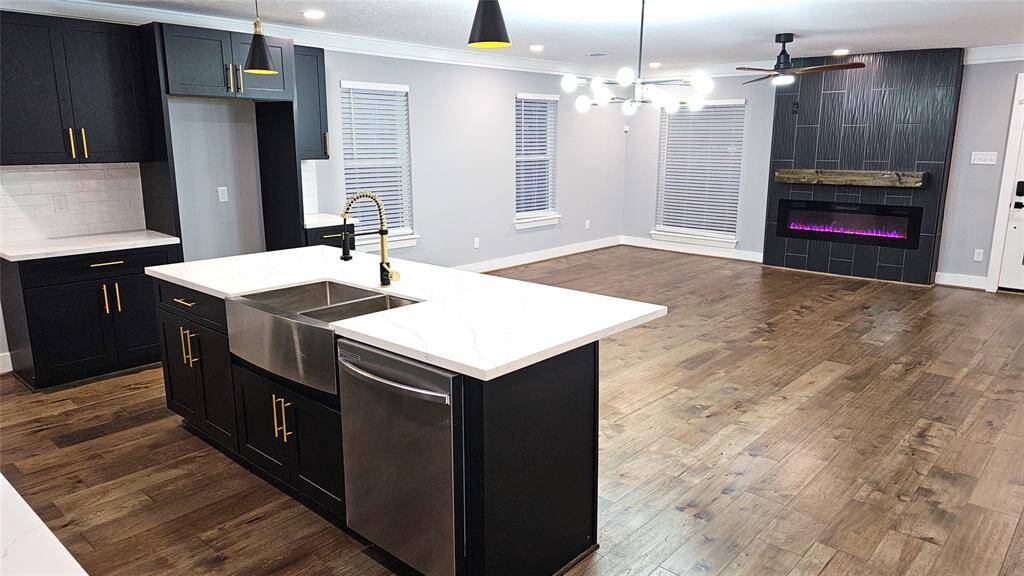 Beautiful Open Concept 30x20 Kitchen, Dining Room and Living Area.  Featuring Modern Fireplace, Solid Wood Matte Black Cabinets with Soft Close Doors/Drawers, Stainless Steel Samsung Smart Appliances, Brushed Gold Hardware and Lighting