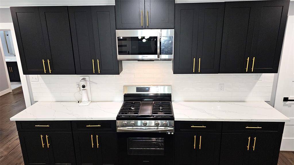 Gourmet Kitchen with Stainless Steel LG Appliances, Solid Wood Cabinets with Soft Close Doors and Drawers, Gold Accents, Beautiful White Subway Tile Backsplash, etc.