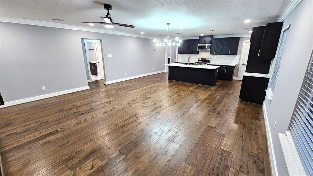 Beautiful Open Concept 30x20 Kitchen, Dining Room and Living Area.  Featuring Modern Fireplace, Solid Wood Matte Black Cabinets with Soft Close Doors/Drawers, Stainless Steel Samsung Smart Appliances, Brushed Gold Hardware and Lighting