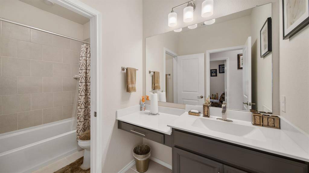 Secondary bathroom features atub/shower combo and long vanitywith plenty of counter space.
