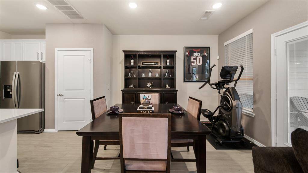 This dining room is bathed in naturallight streaming through a large window and has access to the back patio.