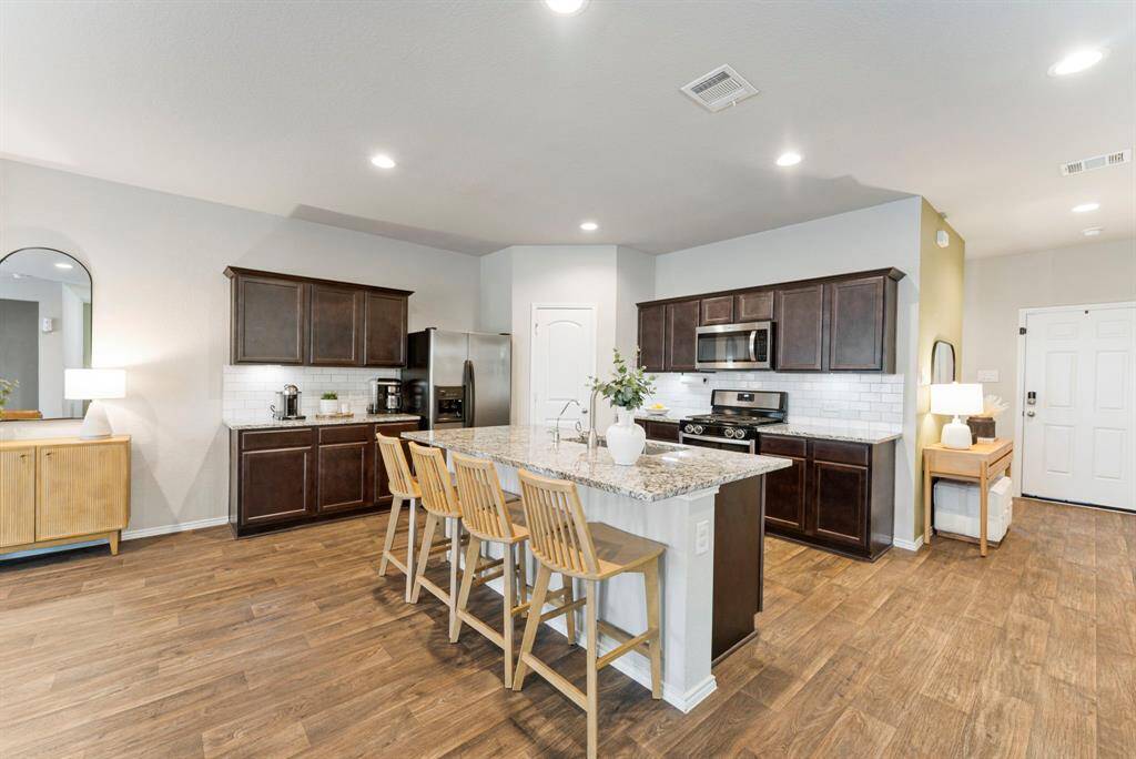 Prepare your favorite meals in this chef's dream kitchen, complete with upgraded granite countertops, subway tile backsplash, new stainless-steel farmhouse sink, faucet, and dishwasher!