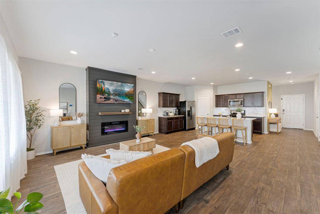 Recently added shiplap enclosed electric fireplace, open to the kitchen for a warm, inviting atmosphere!