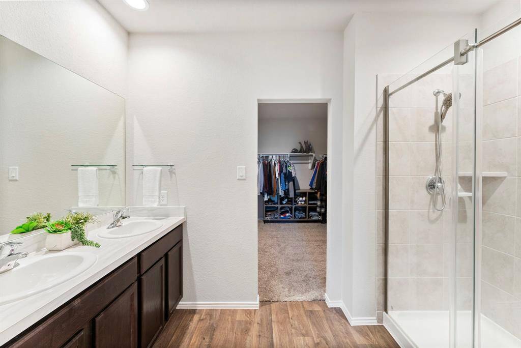 Step inside this huge primary closet, offering plenty of space for all your storage needs!