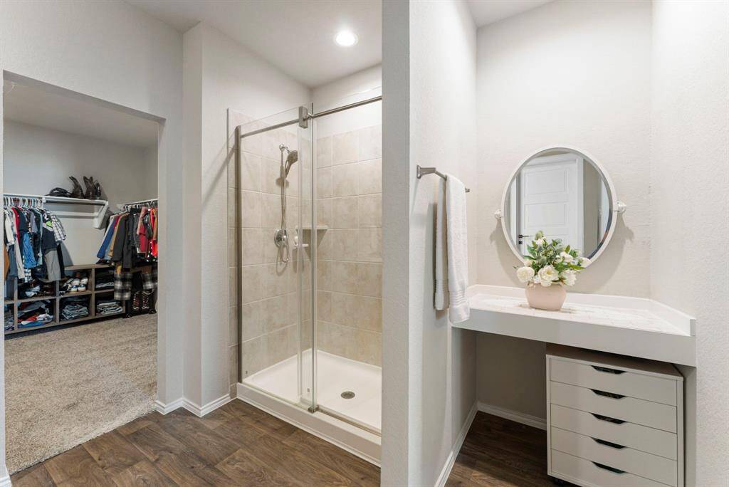 This primary bathroom makes excellent use of space, offering both functionality and style.