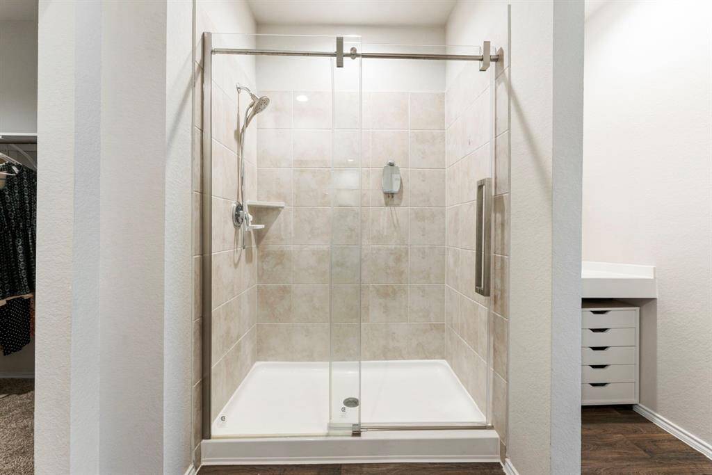 The new glass shower door is a great upgrade, adding a sleek, modern touch and enhancing the bathroom's overall appeal.