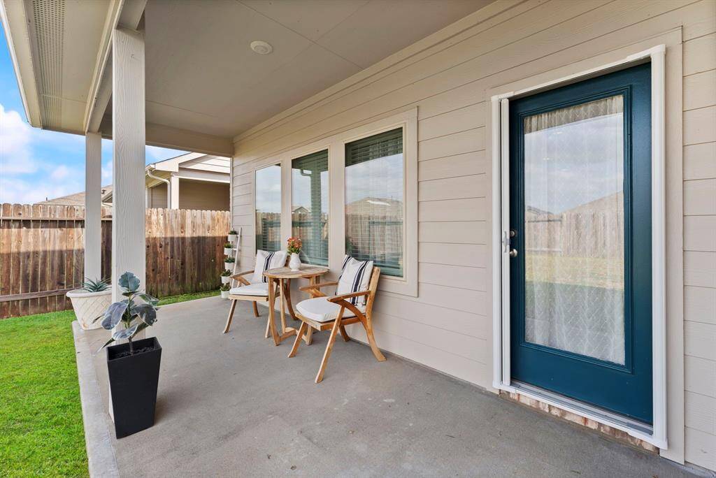Relax on the covered backyard patio after a long day—perfect for unwinding and enjoying the outdoors. You'll also appreciate the upgraded screen door for added convenience.