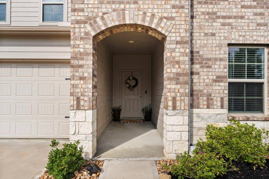 Guests are welcomed by an inviting extended covered porch.