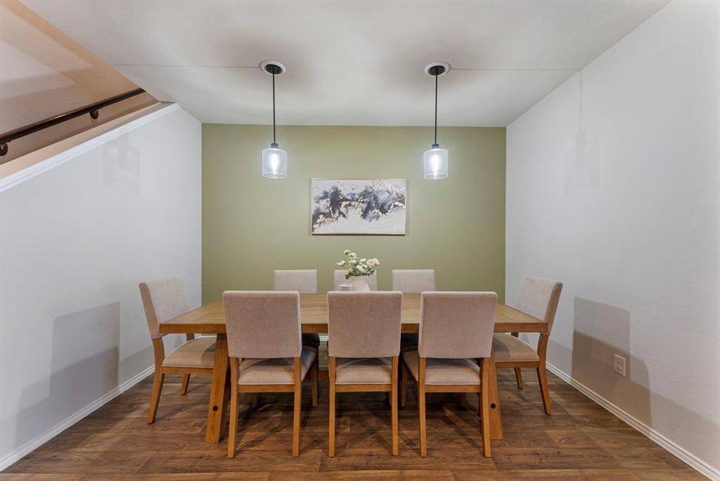 The beautiful dining room, with upgraded lighting & an accent wall, has its own designated space while seamlessly blending into the open floor plan.