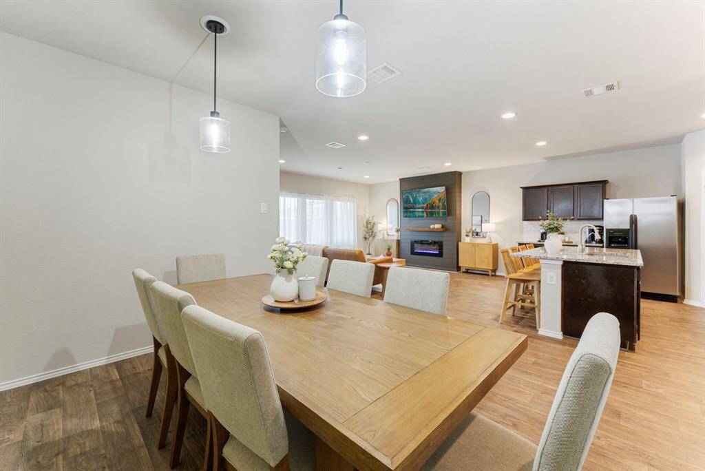 A view into the open floor plan, showcasing the spacious living and kitchen areas from the dining space.