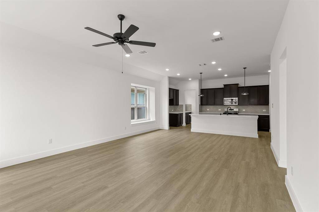 Picture cozy gatherings in a living area that encourages laughter, while the sleek kitchen