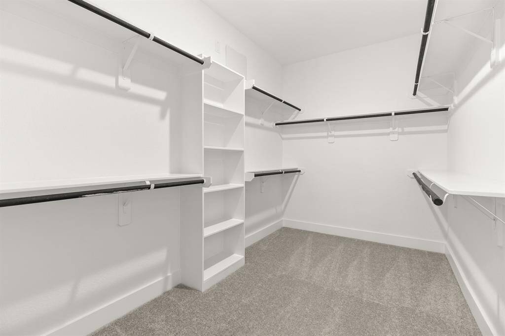 A stylish walk-in closet awaits, providing ample storage for your wardrobe and a little ex