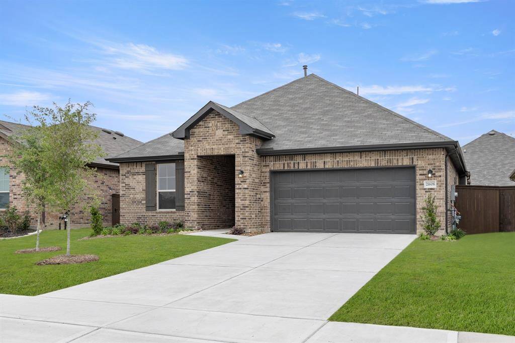 The front exudes curb appeal with its elegant architectural lines, complemented by a fresh