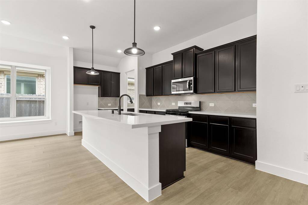 Natural light pours in through large windows, creating a bright and airy atmosphere that m