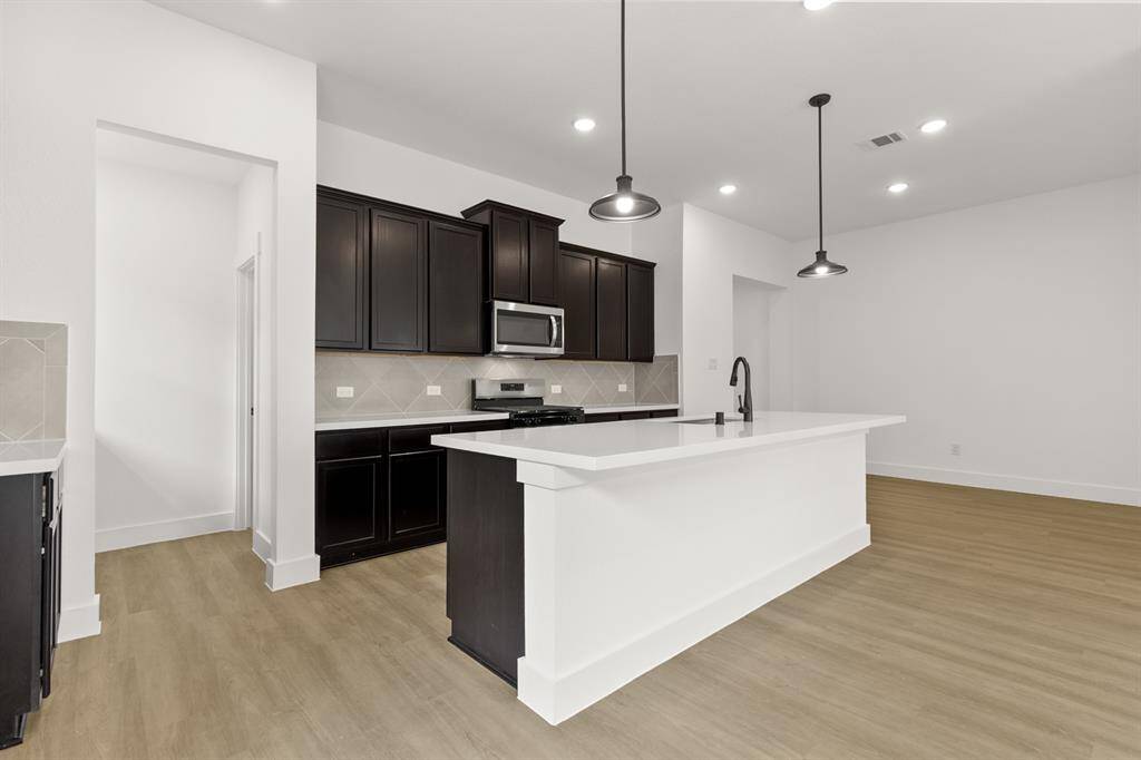 This beautiful brand new kitchen boasts stunning cabinetry that stretches to the ceiling,