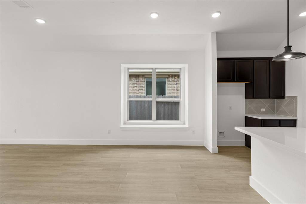 Large windows frame the space, allowing natural light to flood in, casting a cheerful ambi