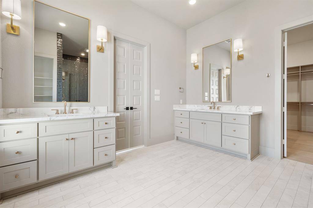 The primary bathroom features "his and hers" sinks with plenty of space for a vanity, combining convenience and style.