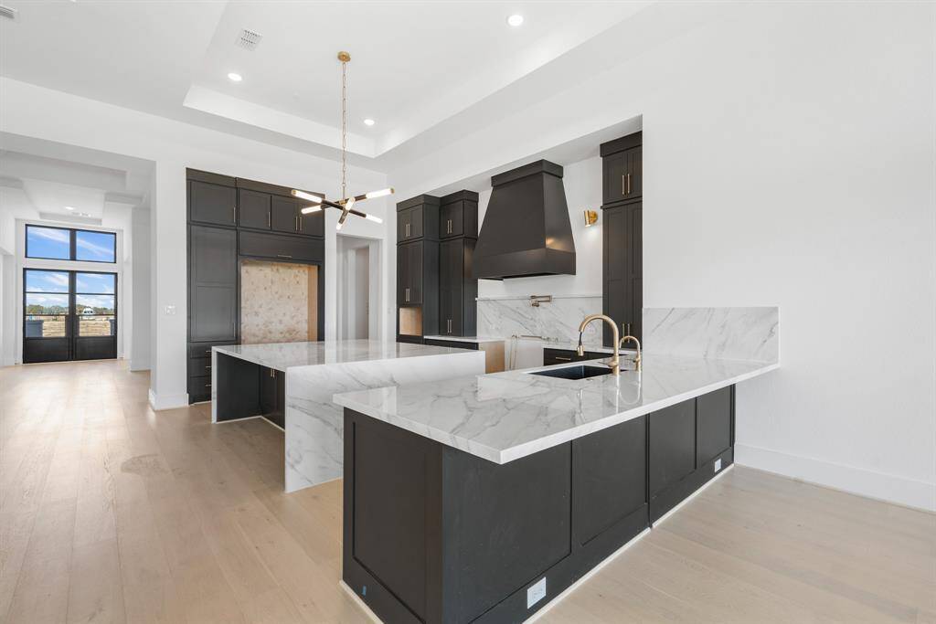 A large kitchen featuring a spacious island, providing ample counter space for cooking and gatherings.