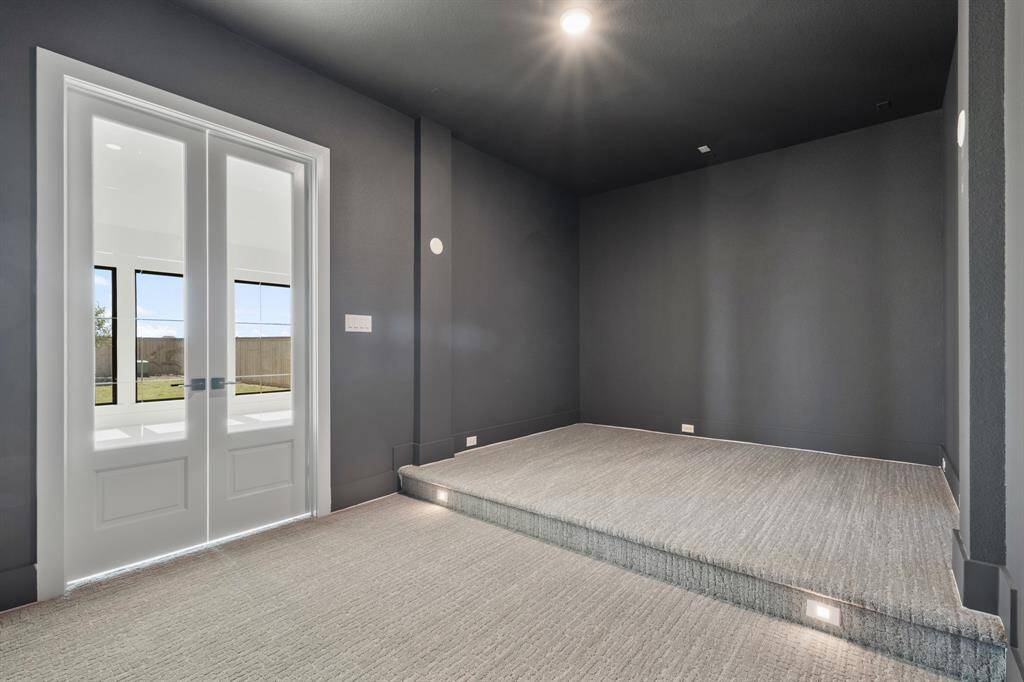 A dedicated theater room with tiered steps, providing an immersive cinematic experience for every viewing.