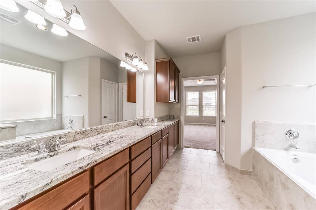 Live in luxury with this impressive primary bath. Perfectly laid out, the stunning finishes included dual sinks, sleek granite countertops, oversized glass encased walk-in shower and a walk-in closet.