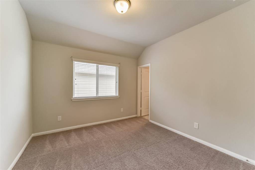 Light and bright secondary bedroom, this light filled room features a large window and a nicely-sized closet.
