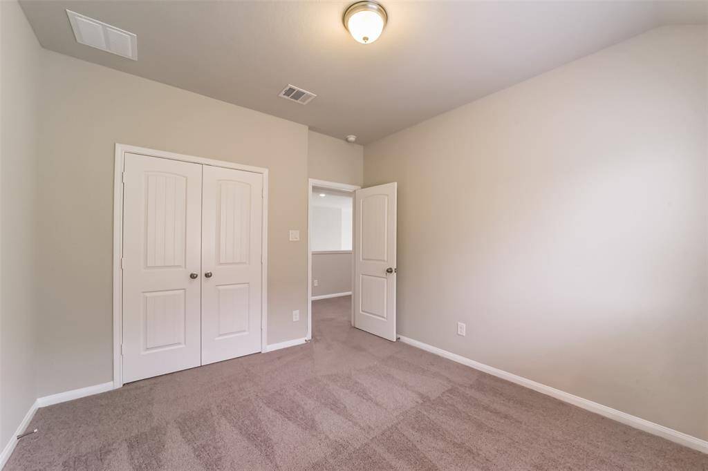 Cozy, this secondary bedroom features ample natural light that highlights the stunning room and gray tones throughout.