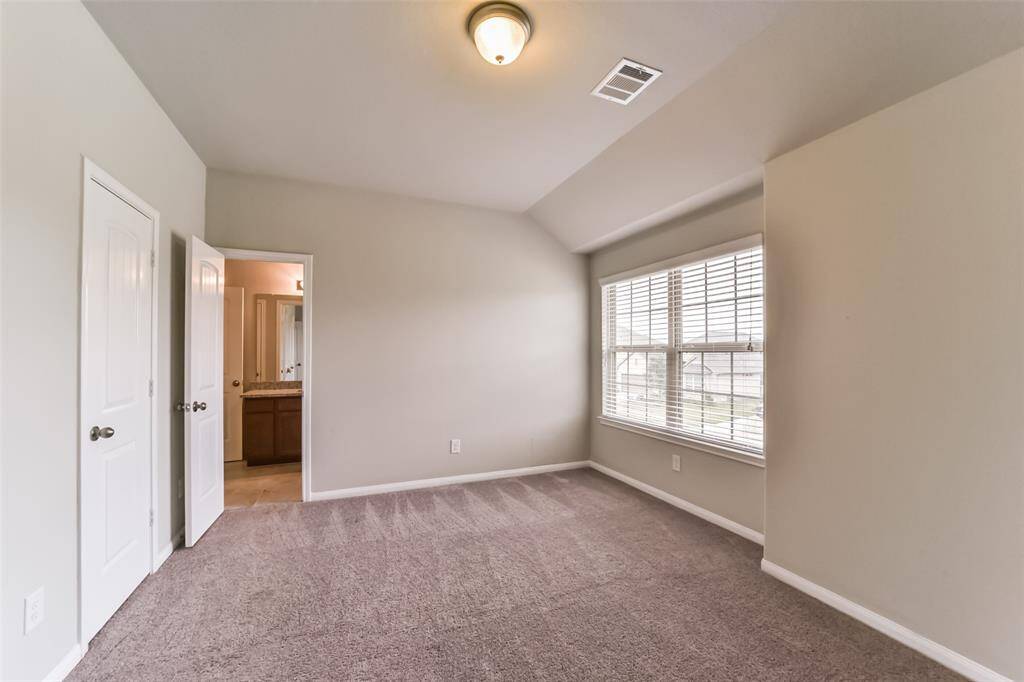 Light and bright secondary bedroom, this light filled room features a large window and a nicely-sized closet.