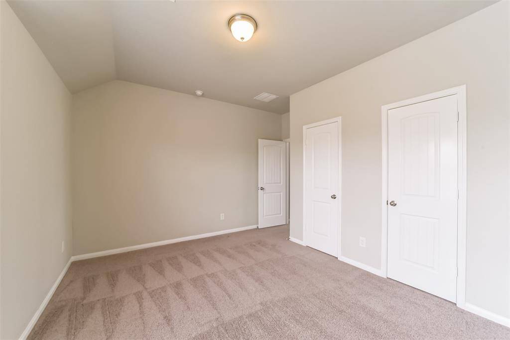 Cozy, this secondary bedroom features ample natural light that highlights the stunning room and gray tones throughout.